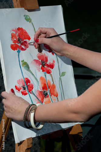 Photo: The artist draws a picture on canvas The artist draws a picture on canvas