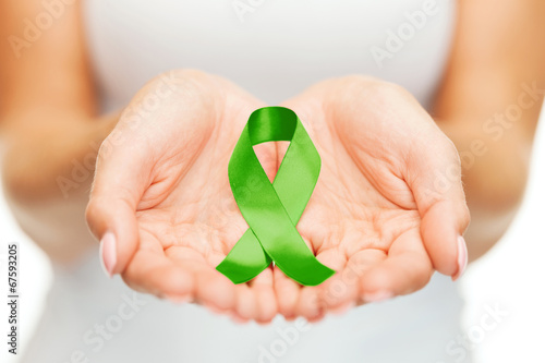 Photo: hands holding green awareness ribbon hands holding green awareness ribbon