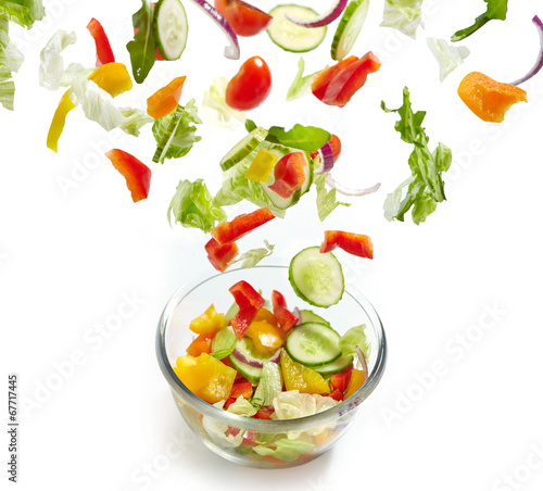 Photo: Fresh vegetables falling into the glass bowl Fresh vegetables falling into the glass bowl