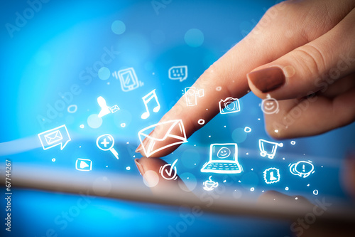 Photo: Finger pointing on tablet pc, social media concept Finger pointing on tablet pc, social media concept