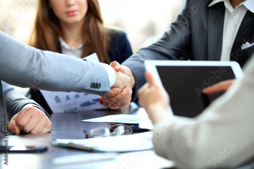 Photo: Business people shaking hands, finishing up a meeting Business people shaking hands, finishing up a meeting