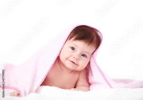 Photo: smiling baby looking at camera under a white blanket/towel smiling baby looking at camera under a white blanket/towel