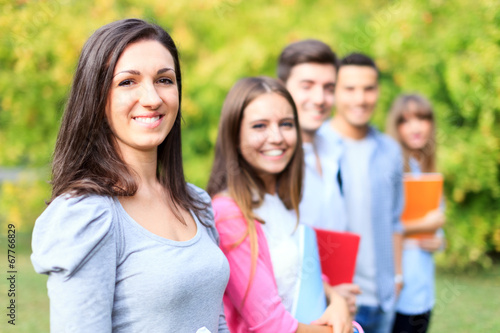Photo: Group of smiling students in a park Group of smiling students in a park