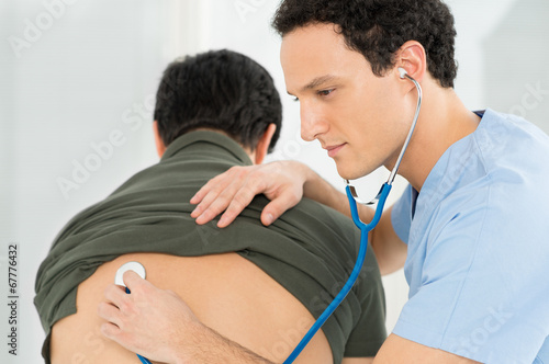 Photo: Doctor Listening The Patient's Lungs Doctor Listening The Patient's Lungs