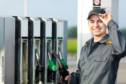Photo: Man holding a fuel nozzle Man holding a fuel nozzle