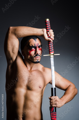 Photo: Man with sword and face paint Man with sword and face paint
