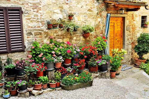 Alley with flowers in Italy - 67913640