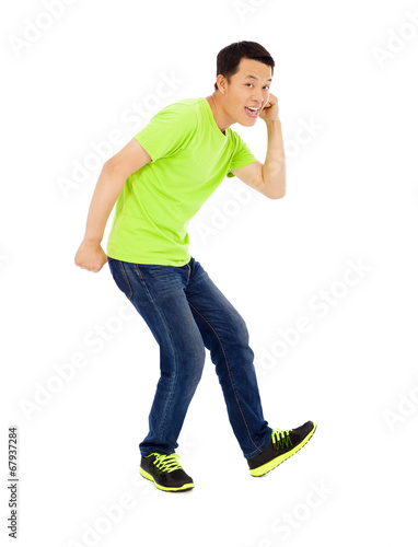 Photo: Young happy man raise hand and funny pose Young happy man raise hand and funny pose
