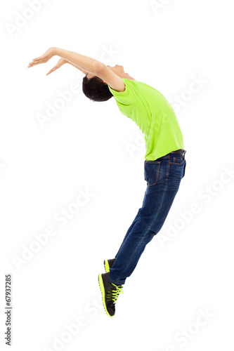Photo: young man jumping and bending his body young man jumping and bending his body