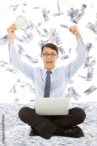Photo: business man holding money and raising hands business man holding money and raising hands