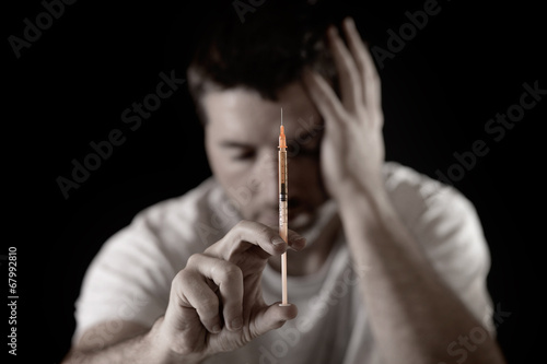 Photo: drug addict man and heroin or cocaine syringe addiction concept drug addict man and heroin or cocaine syringe addiction concept