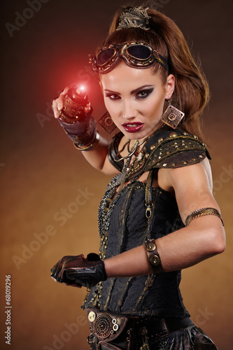 Photo: Steampunk woman over gunge background. . Fantasy fashion for cov Steampunk woman over gunge background. . Fantasy fashion for cov