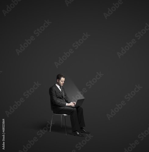Photo: businessman sitting with laptop businessman sitting with laptop
