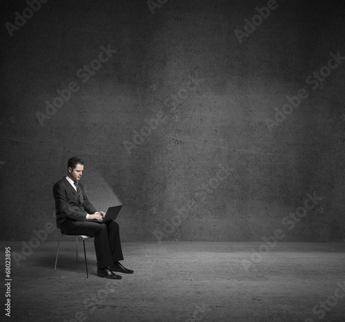 Photo: businessman in dark room businessman in dark room