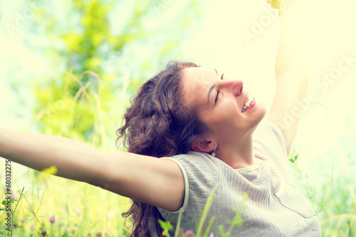 Photo: Beautiful Young Woman Outdoors. Enjoying Nature Beautiful Young Woman Outdoors. Enjoying Nature