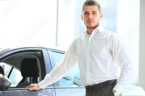 Photo: Handsome man in his new car and smiling at camera Handsome man in his new car and smiling at camera