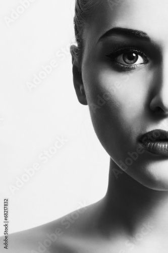 Photo: beautiful woman.close-up monochrome portrait. half face.unusual beautiful woman.close-up monochrome portrait. half face.unusual