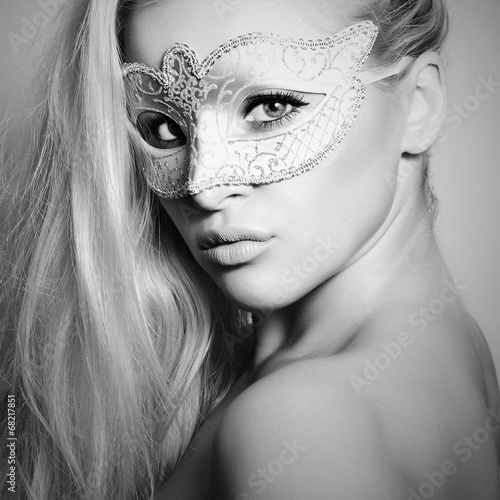 Photo: Beautiful Blond Woman in a Carnival Mask.Masquerade. Monochrome Beautiful Blond Woman in a Carnival Mask.Masquerade. Monochrome