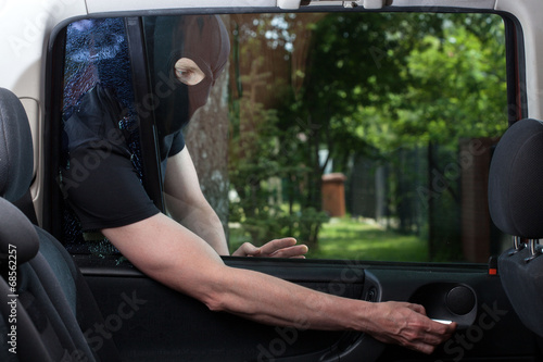 Photo: Burglar opening car door Burglar opening car door
