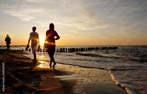 Instant Collection: Friends walking on the beach at sunset Friends walking on the beach at sunset