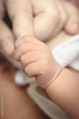 Photo: New-born baby keeps for a mother's finger. New-born baby keeps for a mother's finger.