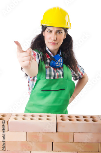 Photo: Woman builder isolated on the white Woman builder isolated on the white