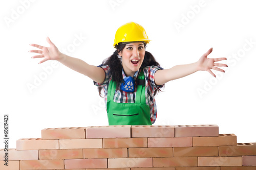 Photo: Woman builder isolated on the white Woman builder isolated on the white