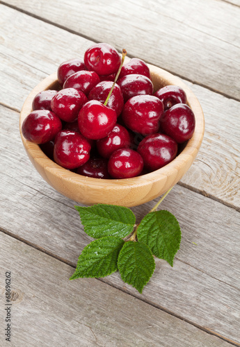 Photo: Ripe cherries on wooden table Ripe cherries on wooden table