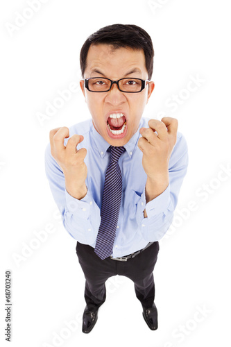 Photo: businessman yelling and make a fist . isolated on white businessman yelling and make a fist . isolated on white