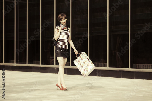 Photo: Happy young fashion woman with shopping bags Happy young fashion woman with shopping bags