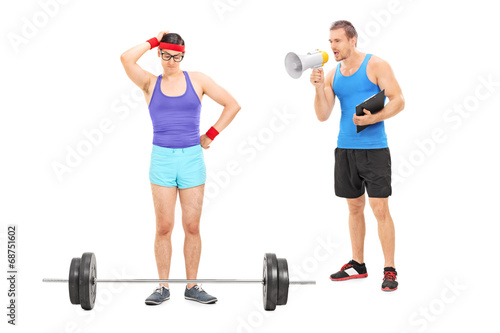 Photo: Coach motivating a nerdy guy to exercise Coach motivating a nerdy guy to exercise