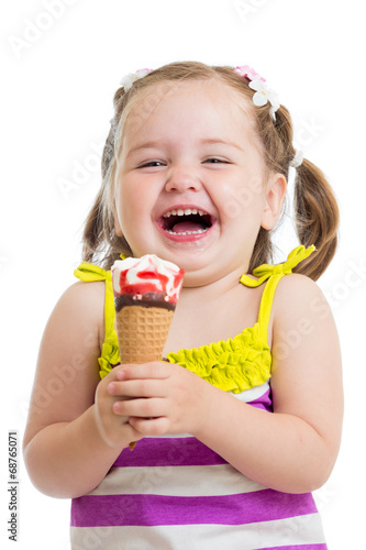 Photo: smiling kid girl eating icecream smiling kid girl eating icecream