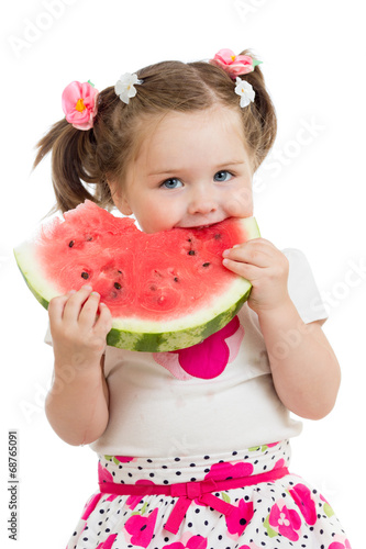 Photo: Kid girl eating watermelon isolated on white Kid girl eating watermelon isolated on white