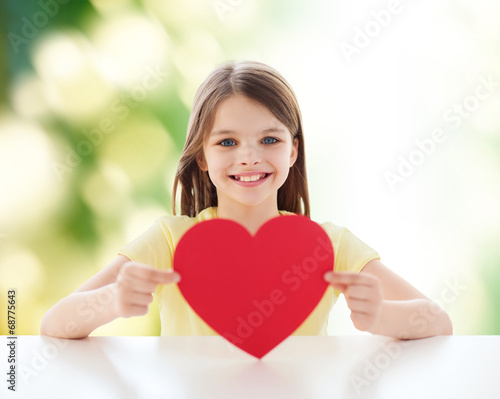 Photo: beautiful little girl sitting at table beautiful little girl sitting at table