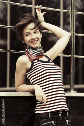 Photo: Happy young fashion woman against mall window Happy young fashion woman against mall window