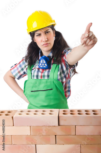 Photo: Woman builder isolated on the white Woman builder isolated on the white