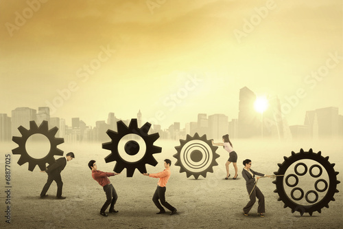 Photo: Teamwork works together to build a gear system Teamwork works together to build a gear system