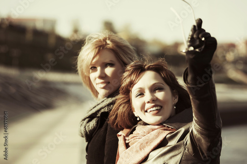 Photo: Two happy young fashion women outdoor Two happy young fashion women outdoor