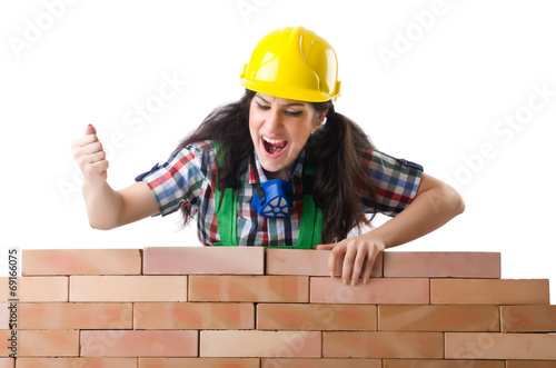 Photo: Woman builder isolated on the white Woman builder isolated on the white