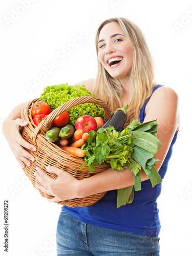 Photo: Young healthy beautiful woman with a basket full of fresh vegeta Young healthy beautiful woman with a basket full of fresh vegeta