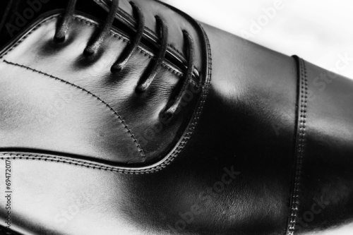 Photo: men's leather shoes closeup on white background men's leather shoes closeup on white background