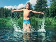 Young boy splashing in the water Young boy splashing in the water