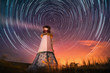 lighthouse with night sky at background stars trails lighthouse with night sky at background stars trails