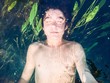 Boy submerged in a pure river Boy submerged in a pure river