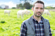Young attractive farmer working in a field