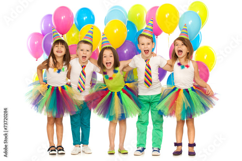 Group of joyful little kids having fun at birthday party