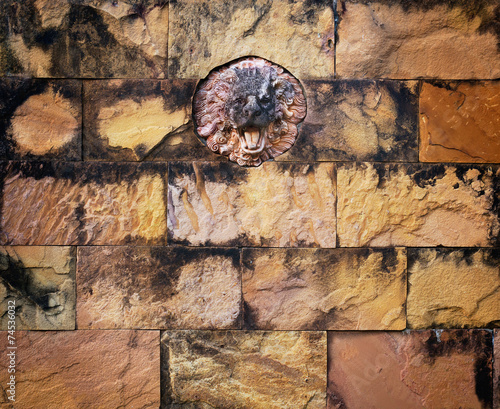 colorful stained lion stone and old brick wall background