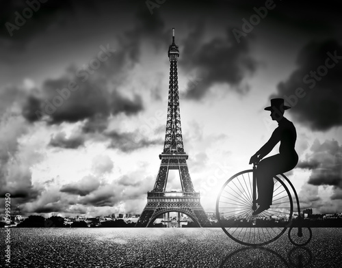  Man on retro bicycle next to Effel Tower, Paris, France.