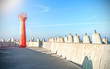 Photo of a lighthouse and concrete block breakwater. Photo of a lighthouse and concrete block breakwater.