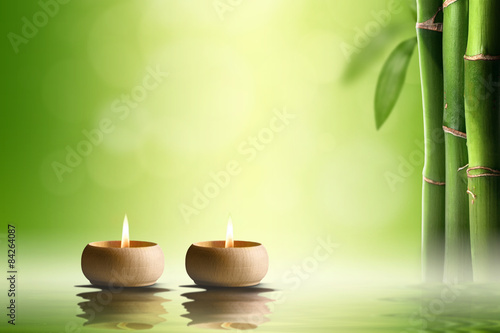  Zen concept. Two candles in bamboo forest.